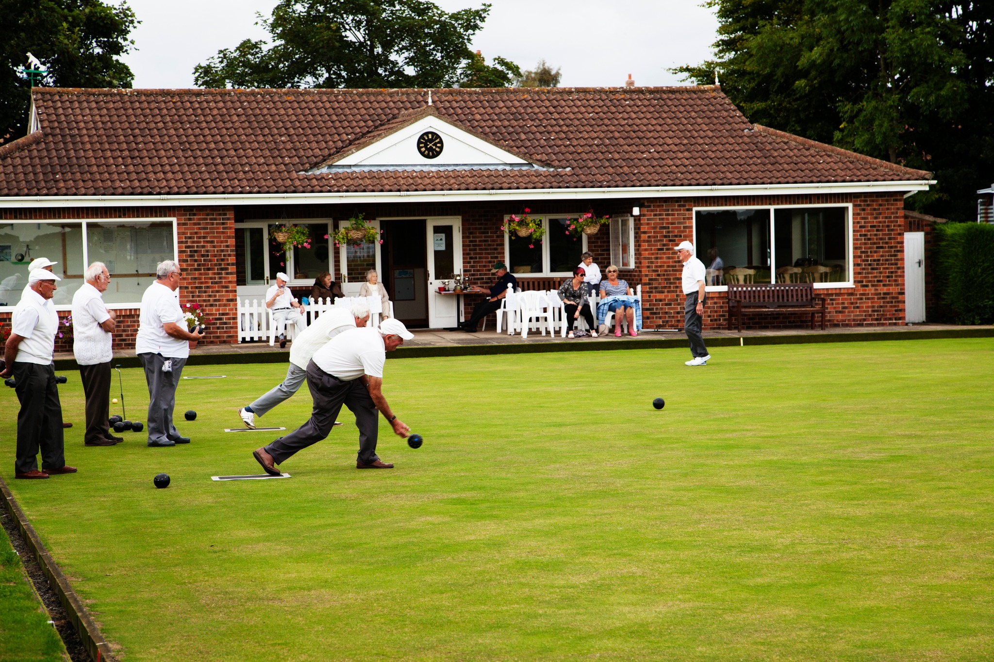 Bowlers with clubhouse in the background.